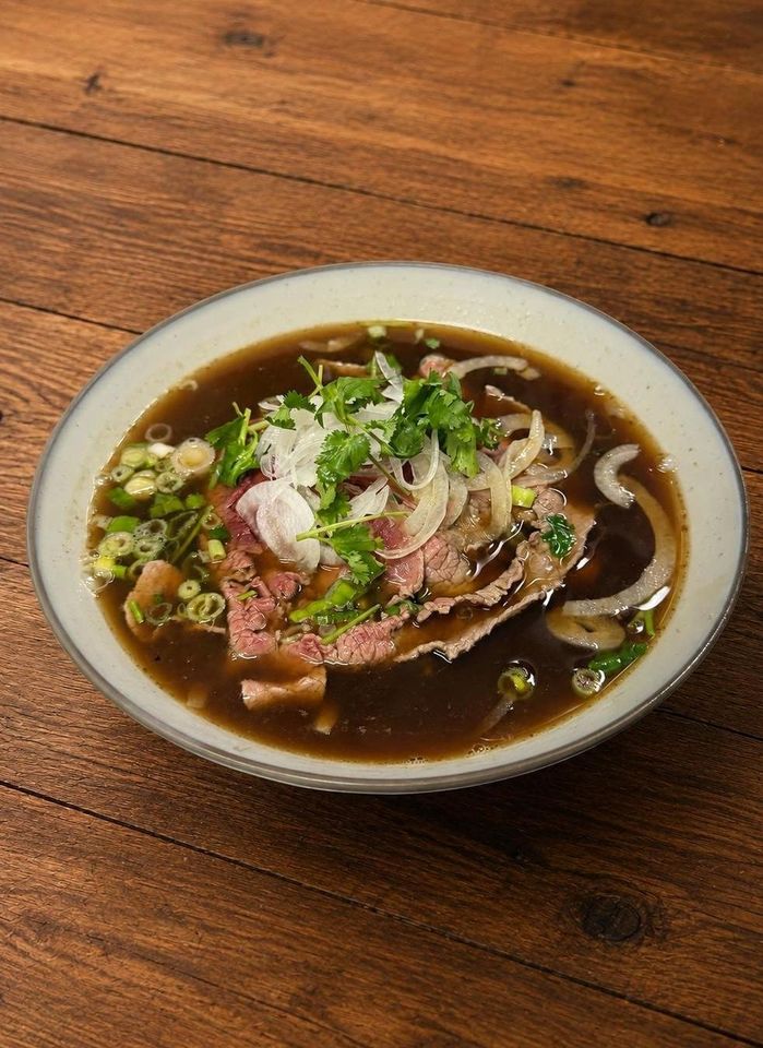 Pho Beef rice noodle soup with sliced beef, scallions, and cilantro